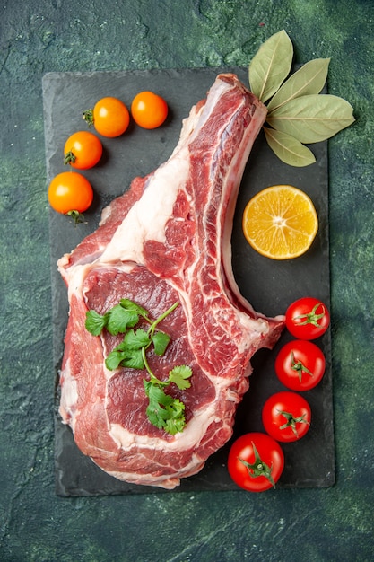 Вид сверху ломтик свежего мяса с помидорами на темно-синем фоне еда мясо кухня животное корова мясник цвет курицы