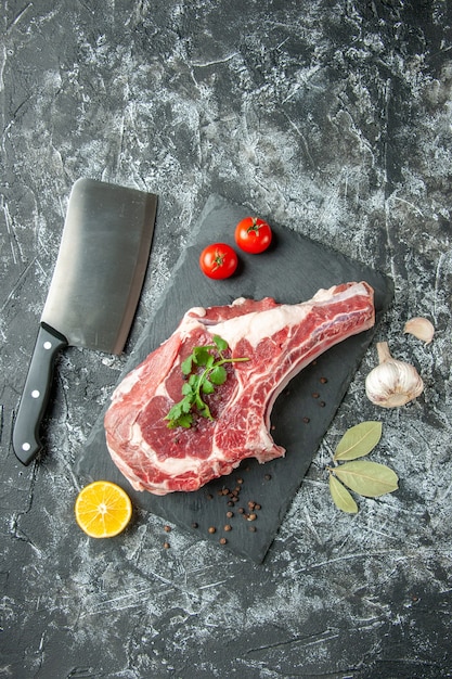 Top view fresh meat slice with tomatoes on a light-gray background kitchen animal cow chicken food color butcher meat