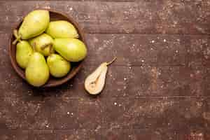 Free photo top view fresh mellow pears green and juicy on a brown space