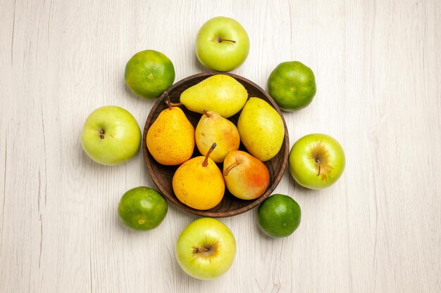 Top view fresh mellow pears sweet fruits with apples and tangerines on white desk fruit yellow fresh ripe sweet