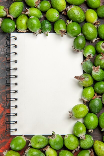 Top view of fresh natural green feijoas small vitamin bomb and notebook