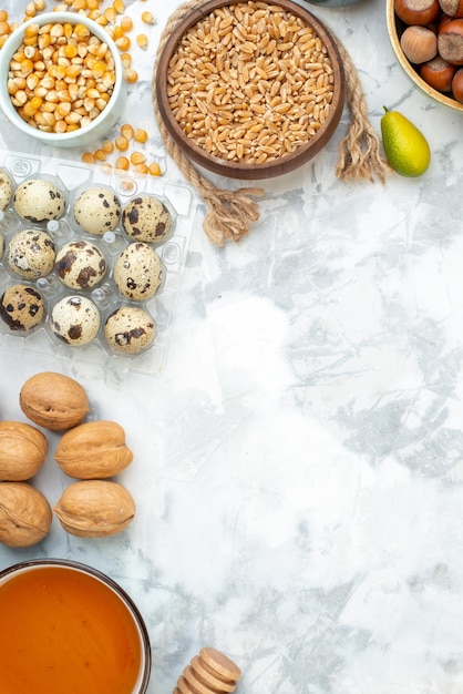 Top view fresh nuts with flour eggs and milk on the white background photo color cake pie hotcake bun biscuit dough