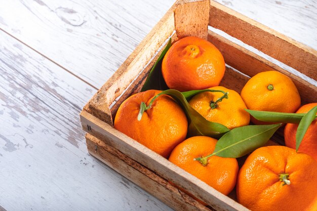 Top view fresh oranges in wooden box