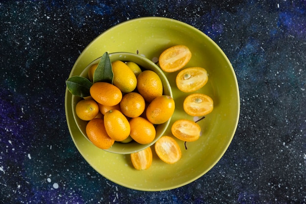 Top view of Fresh organic kumquats whole or half cut 