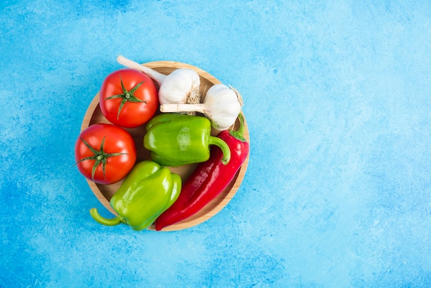 Top view of fresh organic vegetables on wooden board