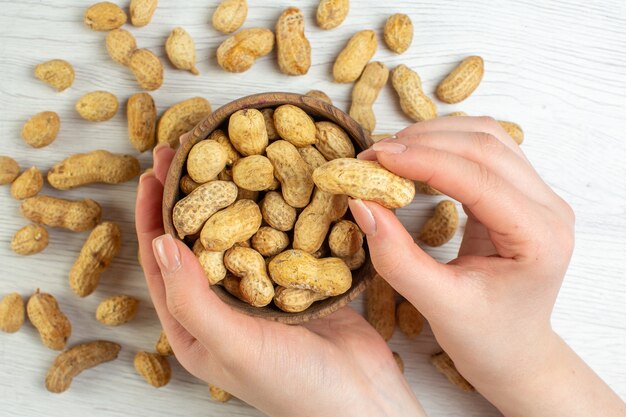 Top view fresh peanuts on white table