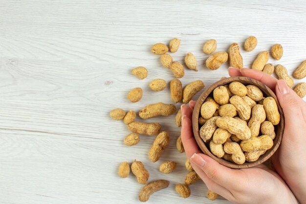 Top view fresh peanuts on white table