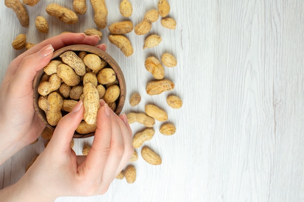 Free photo top view fresh peanuts on white table