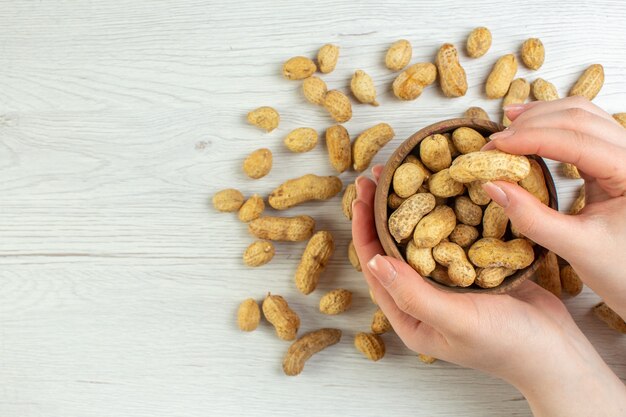 Free photo top view fresh peanuts on white table