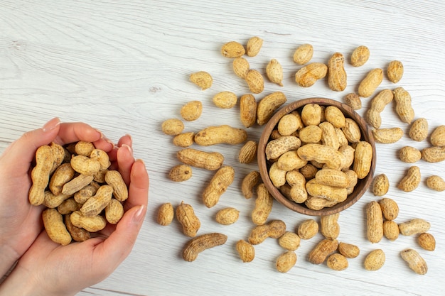 Top view fresh peanuts on white table