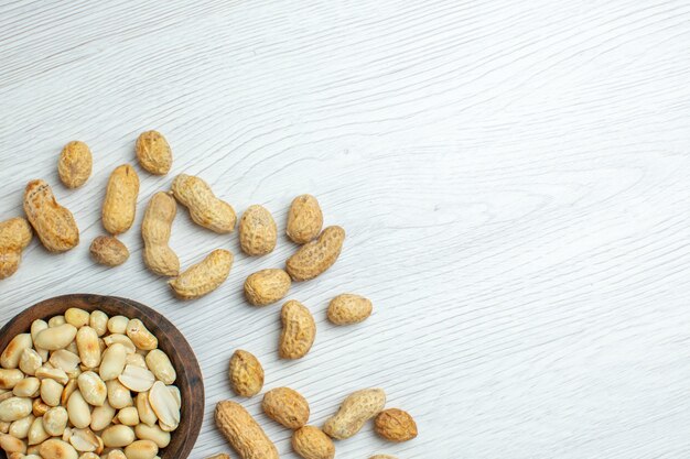 Top view fresh peanuts on white table