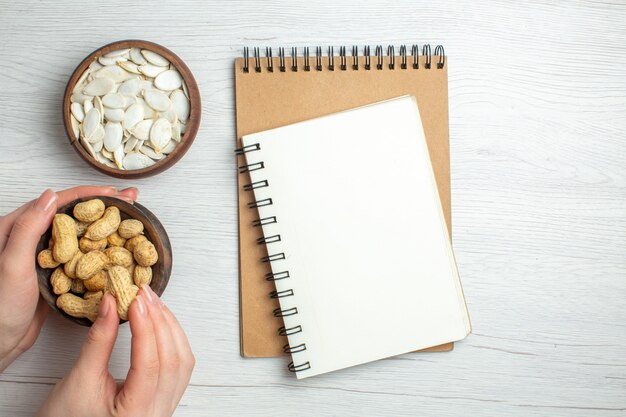 Top view fresh peanuts with white seeds on white table