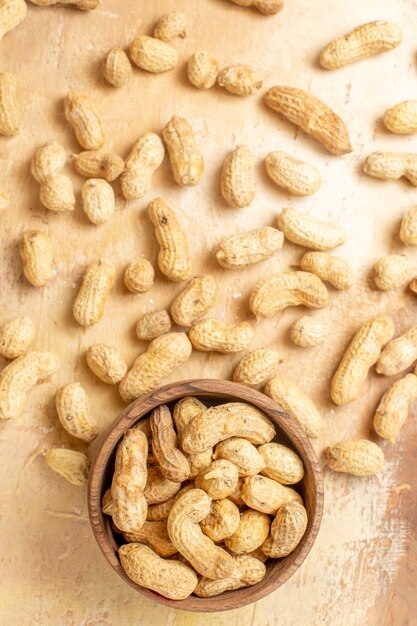 Top view of fresh peanuts on wooden desk