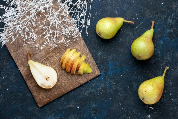 Top view of fresh pears whole sliced and sweet on dark-blue desk, fruit fresh mellow food