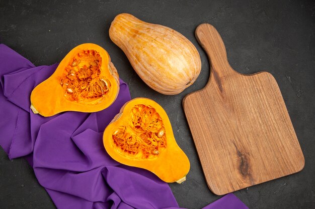 Free photo top view of fresh pumpkin sliced fruit on a dark background