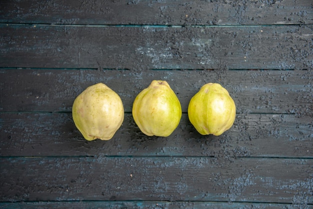 Top view fresh quinces mellow and sour fruits on dark-blue desk ripe fetus fresh tree sour plant