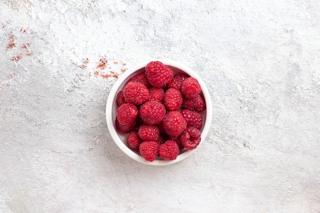 Top view fresh raspberries inside plate on white surface berry fruit plant wild tree