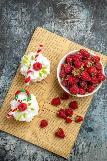 Top view fresh raspberries with cakes