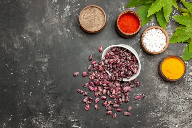 Free photo top view fresh raw beans with seasonings on a grey surface