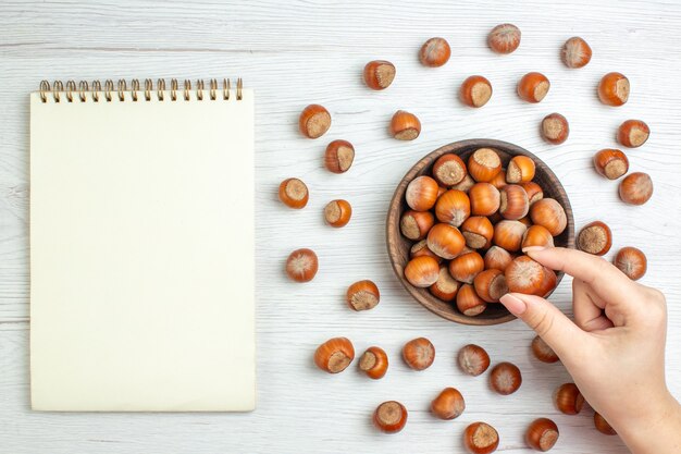 Top view fresh raw hazelnuts on white desk nut movie plants food walnut snack