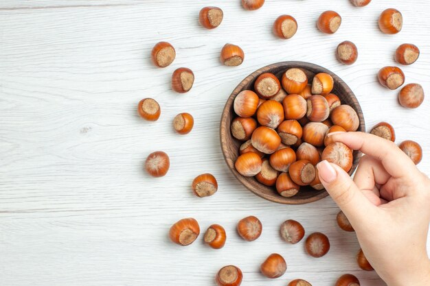 Top view fresh raw hazelnuts on white desk nut snack movie plants food walnut