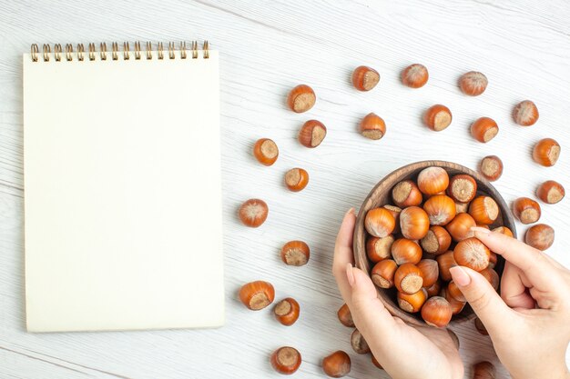 Top view fresh raw hazelnuts on white desk