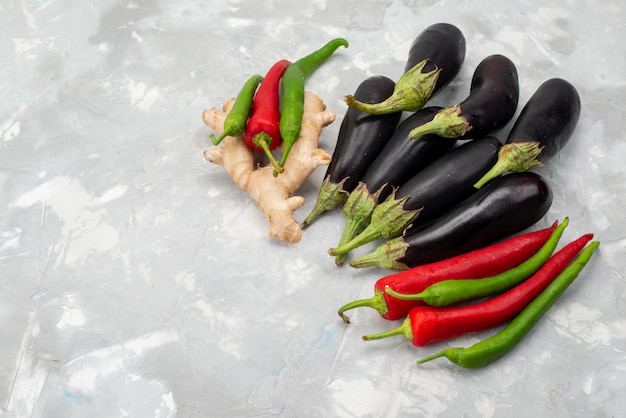 Top view fresh raw vegetables peppers and eggplants on the light background vegetable fresh tree food meal