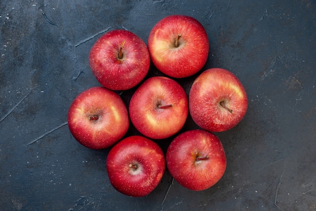 Top view fresh red apples on dark table