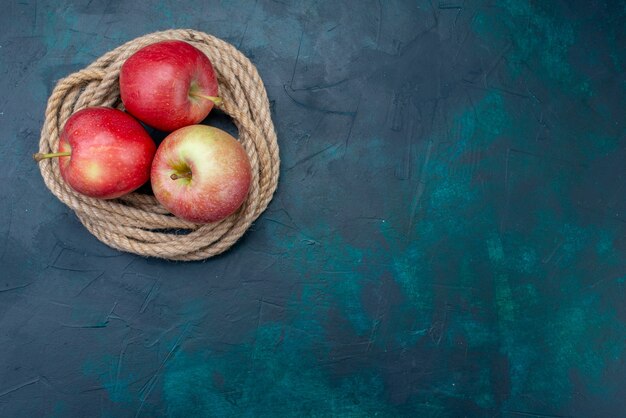 Top view fresh red apples juicy and mellow on dark blue background ripe fruit fresh vitamine