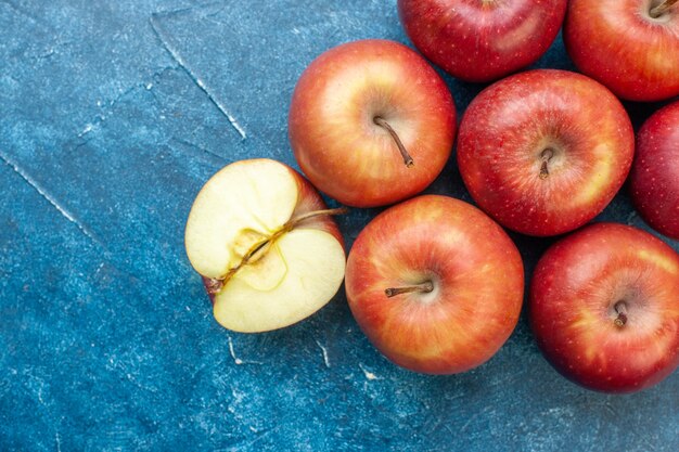 Top view fresh red apples lined on the blue table