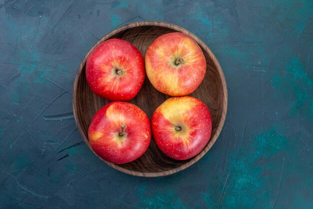 짙은 파란색 책상 위의 신선한 빨간 사과 부드럽고 신선한 과일