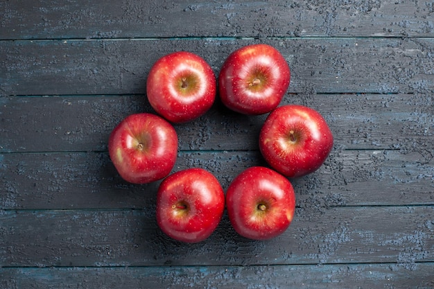 Top view fresh red apples mellow and ripe fruits on dark-blue desk fruit whole color red plant vitamine fresh