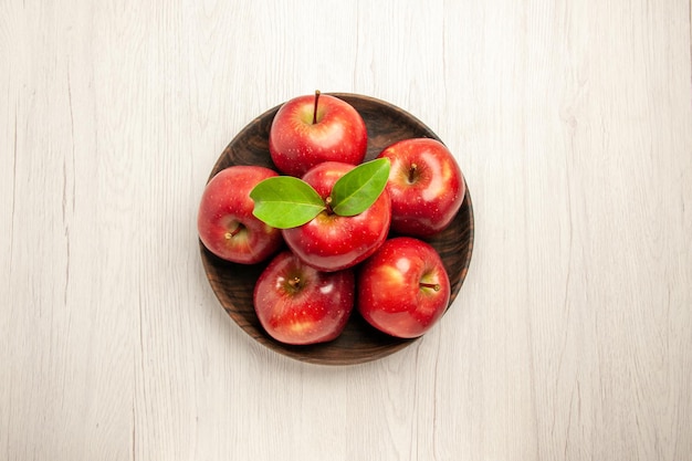 Top view fresh red apples ripe and mellow fruits on a white desk fruit red color tree fresh plant