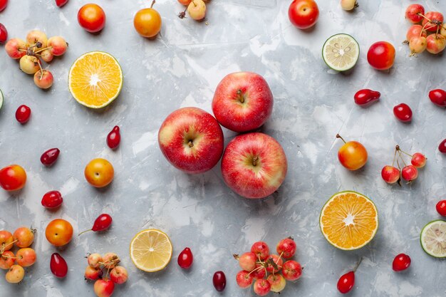 Top view fresh red apples with lemon and cherries on the white desk fruit berry vitamine summer mellow