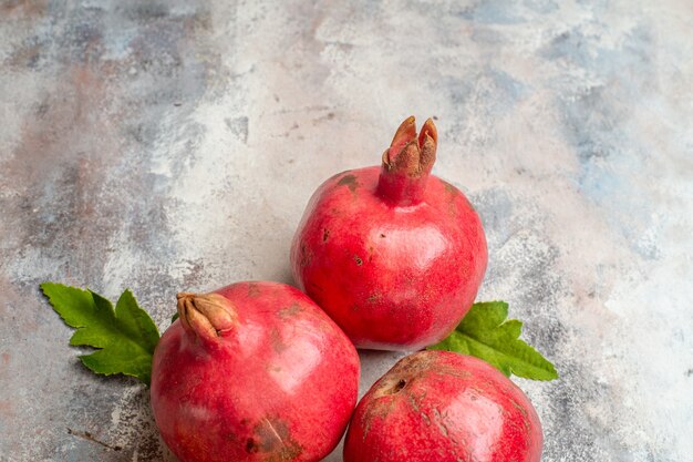 Top view fresh red pomegranates on light background