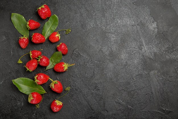 Top view fresh red strawberries on dark grey table berry ripe fruit color