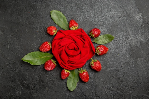 Top view fresh red strawberries on dark table, fruit berry ripe color