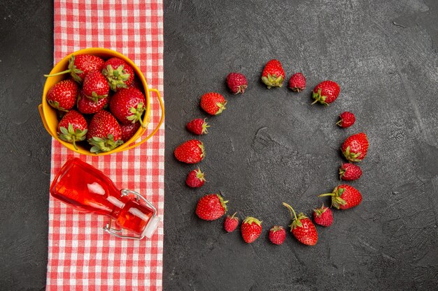 Top view fresh red strawberries on dark table fruits berry color raspberry