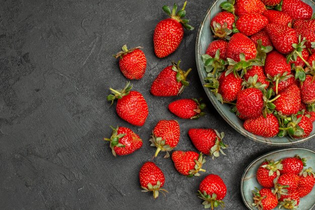 Top view fresh red strawberries on grey background