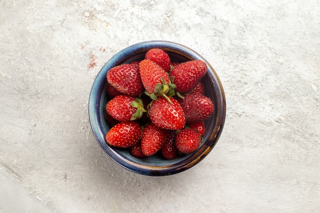 Top view fresh red strawberries inside plate on white space