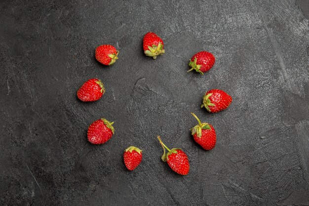 Top view fresh red strawberries lined on dark table color fruit berry ripe