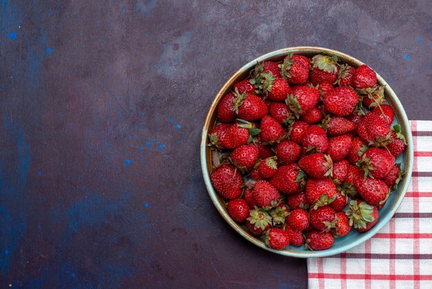 Top view fresh red strawberries mellow berries inside round bowl on the dark background fruit berry fresh ripe