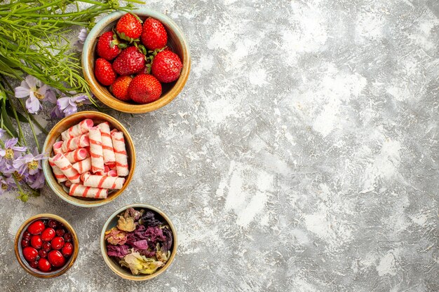 Top view fresh red strawberries with flowers on a white surface berry fruit red candy