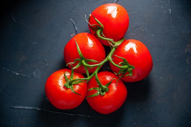 Top view fresh red tomatoes on the dark surface