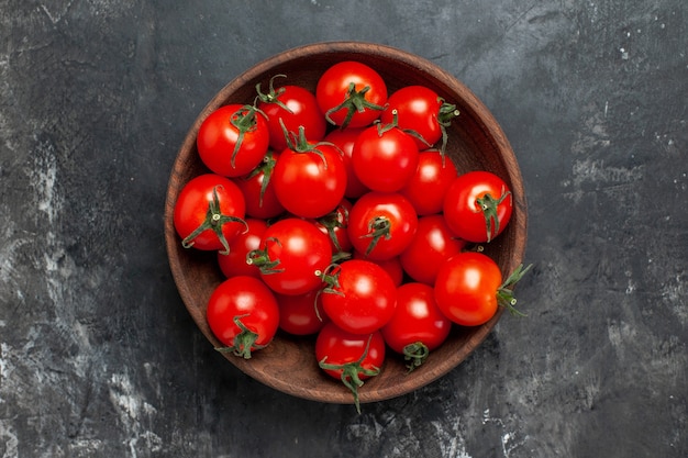 Top view fresh red tomatoes inside plate on dark background