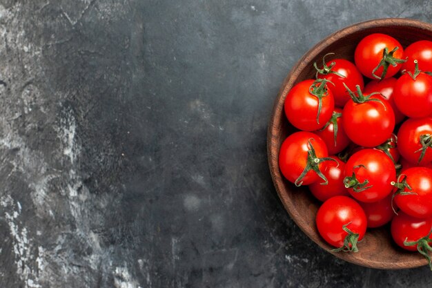 Top view fresh red tomatoes inside plate on dark background