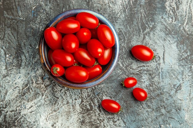 Top view fresh red tomatoes inside plate on dark-light table fruit photo dark salad