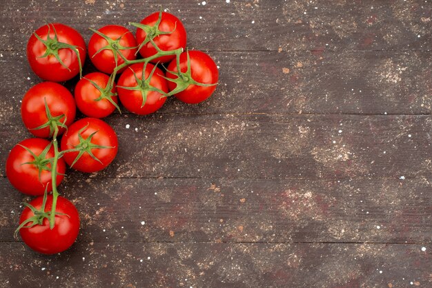 Top view fresh red tomatoes ripe and whole on wooden brown