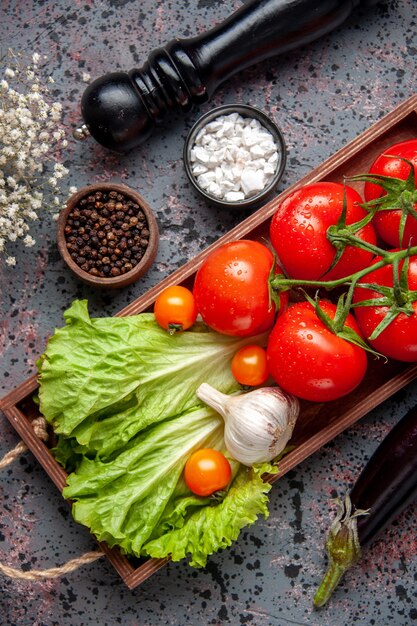 top view fresh red tomatoes with garlic and green salad inside wooden board on blue surface food lunch salad ripe color meal