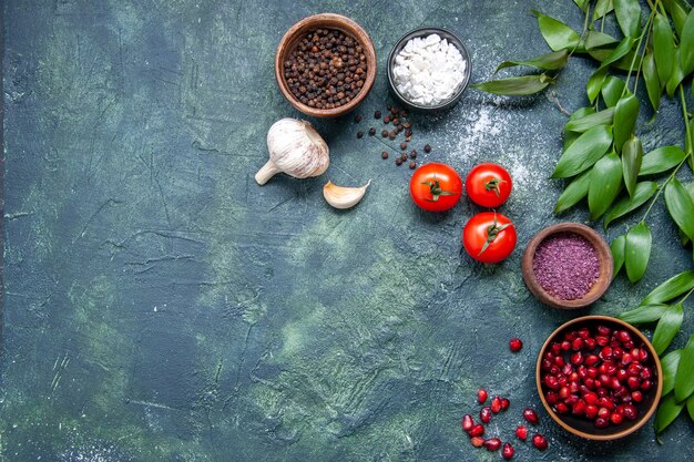 Top view fresh red tomatoes with garlic and seasonings on dark background color ripe salad meal photo health diet